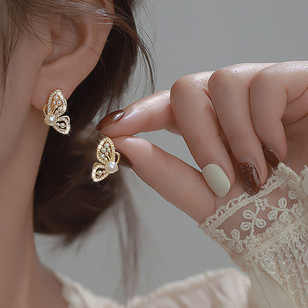 Gold Butterfly Earrings Adorned with Shimmering Pearls