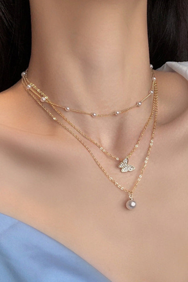 Gold Butterfly Necklace Adorned with a Pearl and Sparkling Glitter